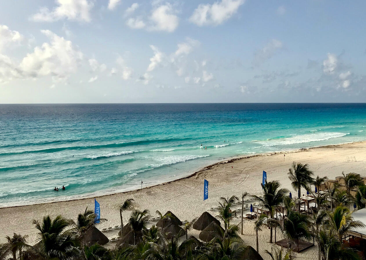 Turquoise Caribbean Sea and white sand beach in Cancun Mexico